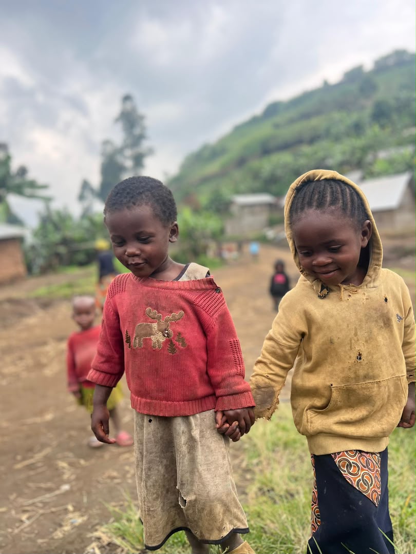Two children holding hands on a road in Goma, eastern DRC